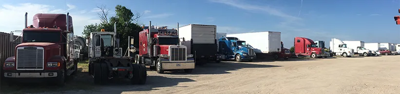 Row of semi trucks parked at the Southern Diesel Repair shop yard