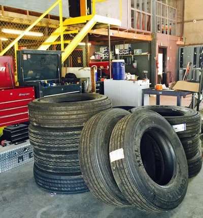 Stack of commercial truck tires inside the SDR shop